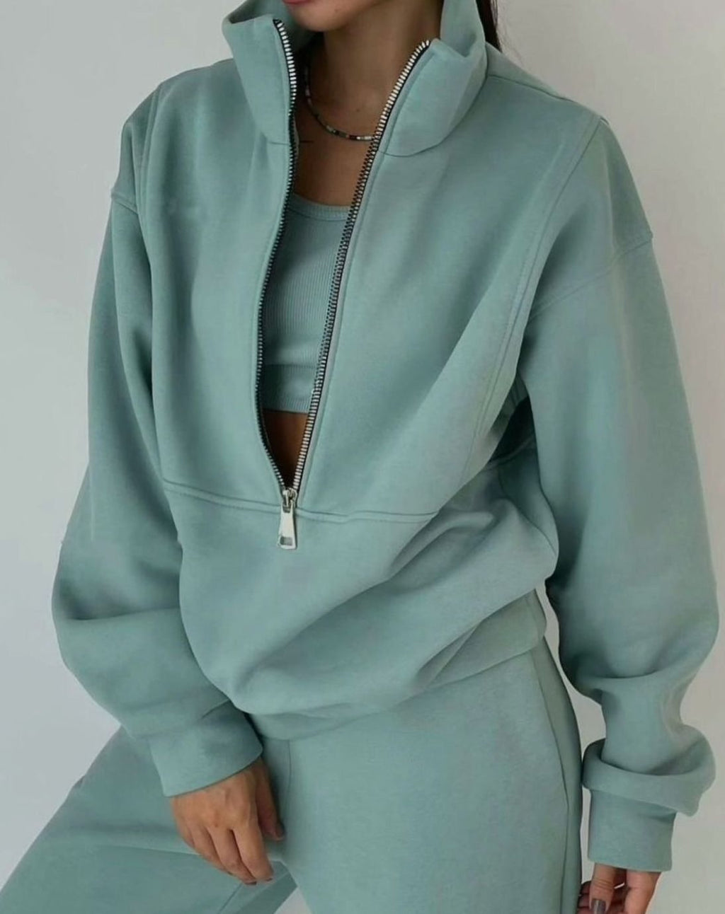 Women's cropped half-zip tracksuit set with raised collar and matching trousers
