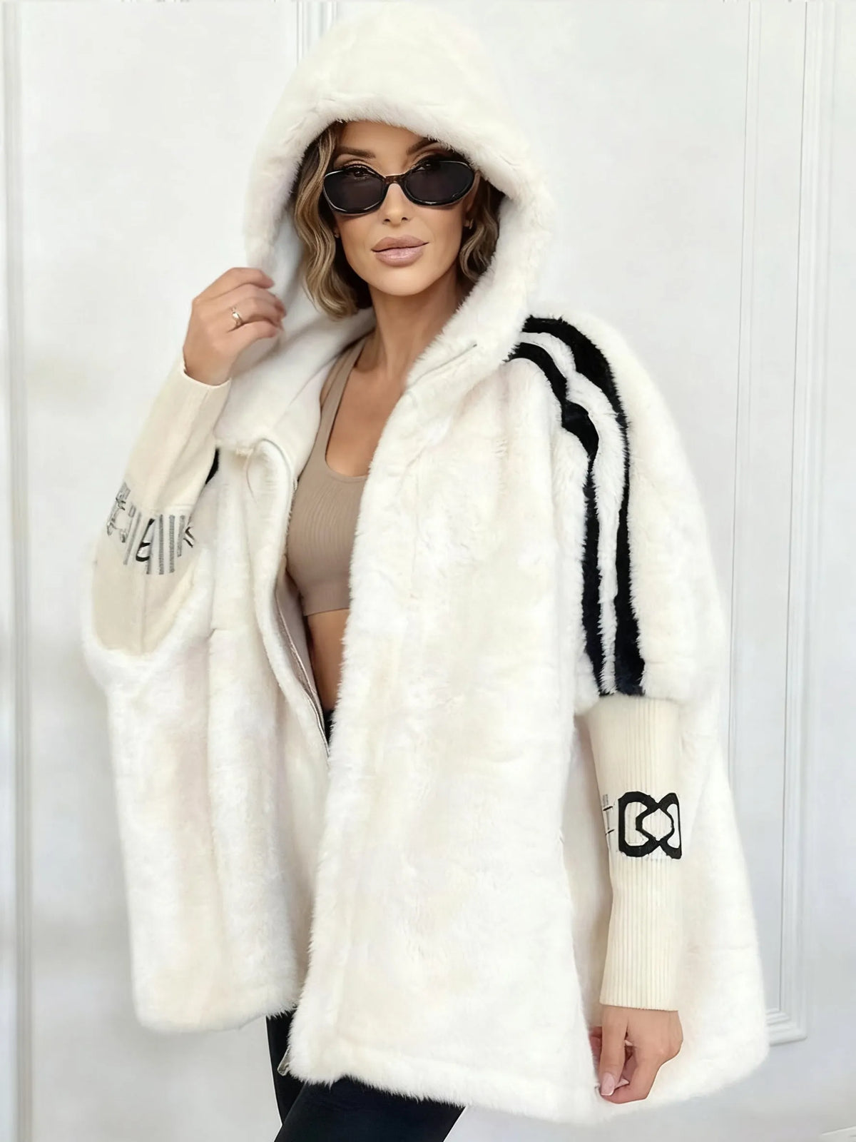 Women's oversized hooded faux fur longline coat with zip front and contrast sleeve detailing