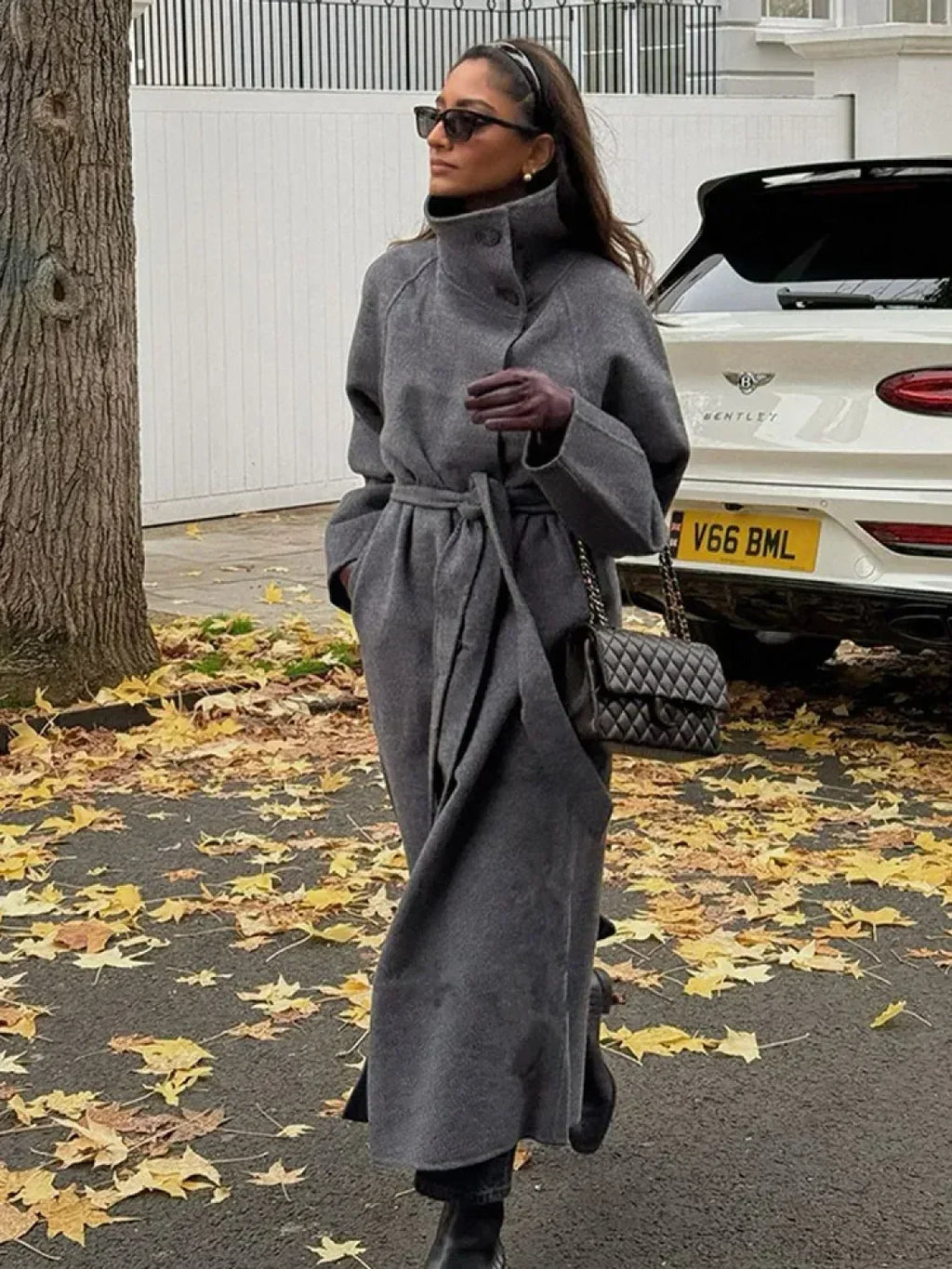 Women's grey long belted coat with raised stand collar and button front