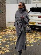 Women's grey long belted coat with raised stand collar and button front
