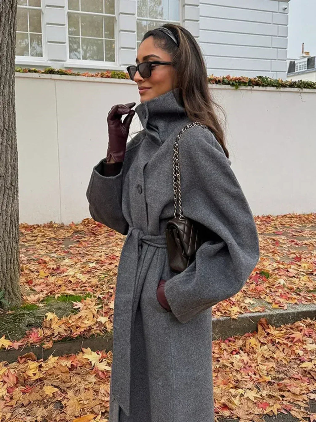 Women's grey long belted coat with raised stand collar and button front