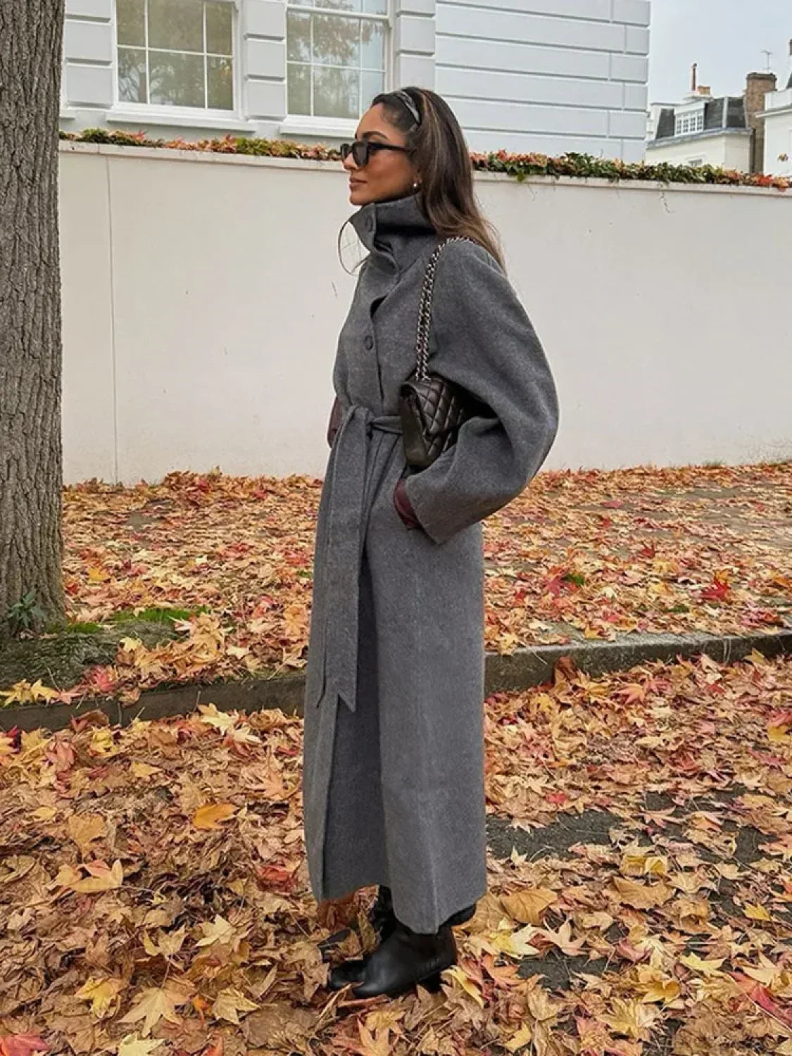 Women's grey long belted coat with raised stand collar and button front