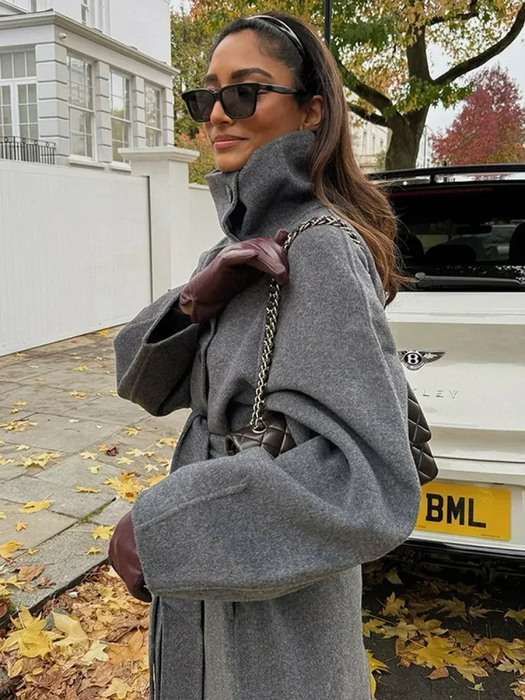 Women's grey long belted coat with raised stand collar and button front