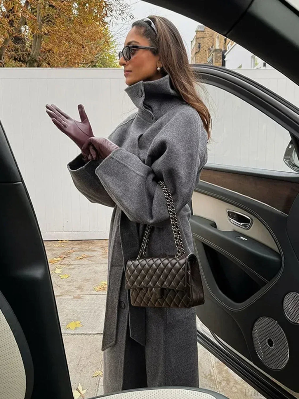 Women's grey long belted coat with raised stand collar and button front